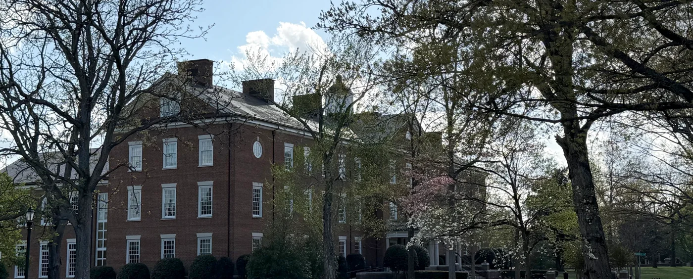 A red-brick building with white-framed windows among old trees on the Hampden-Sydney College campus